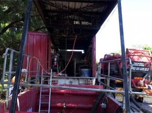 Downer ACT Hook truck and Gantry Truck Setup next to road