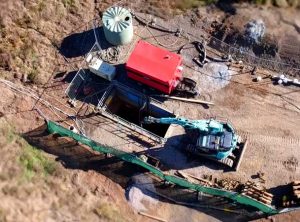 Rileys Creek Pezzimenti Excavator craning rods into shaft