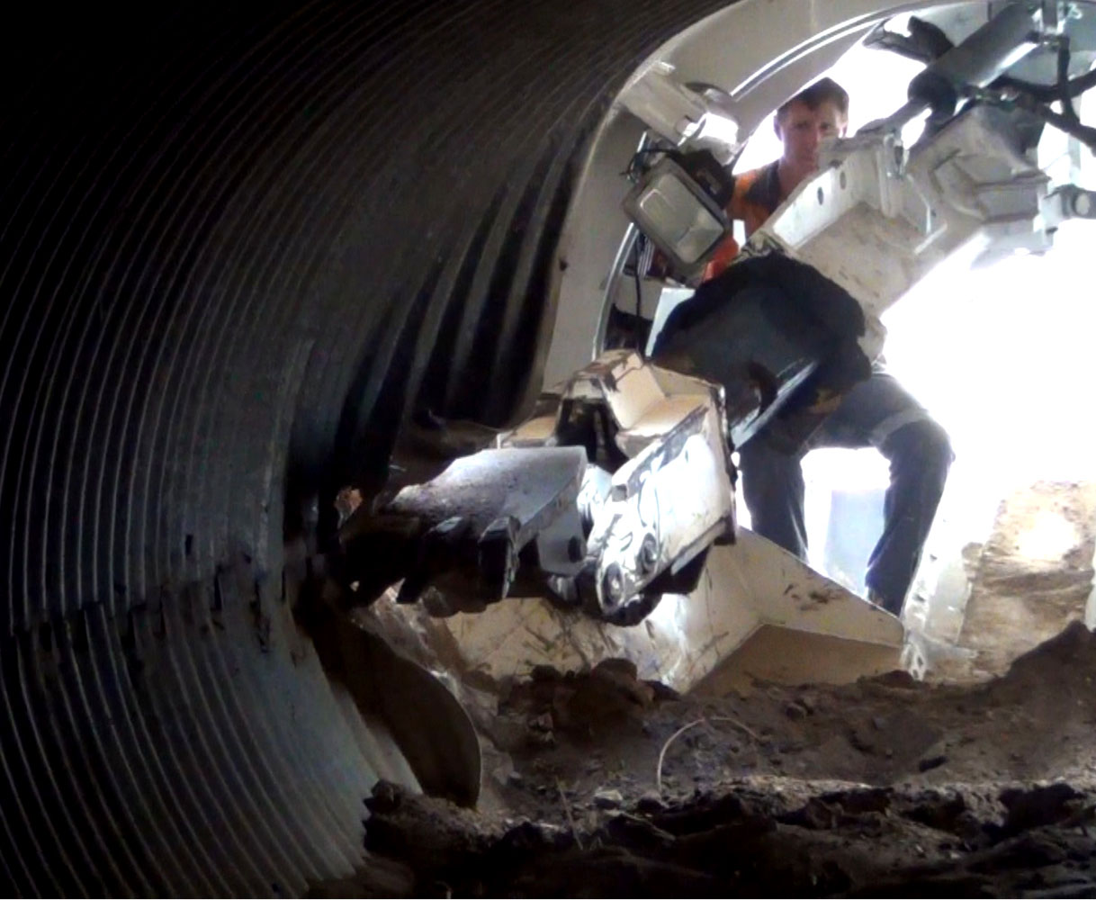 Pezzimenti Culvert Replacement Digger Arm Dismantles a Corrugated Steel Pipe Culvert